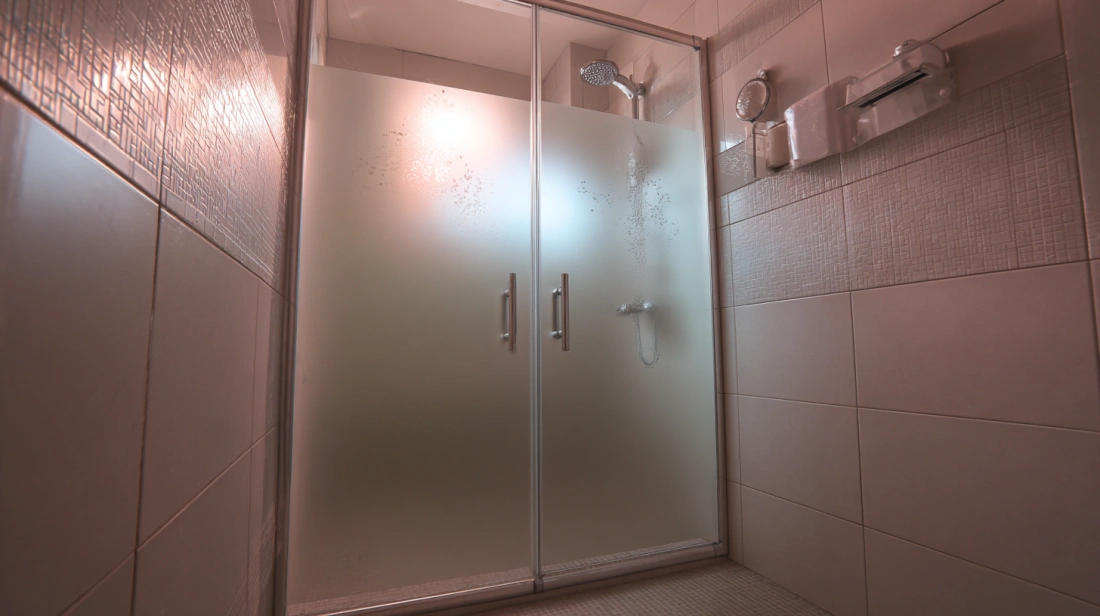 Frameless shower glass partition enclosure custom-built for a Bengaluru bathroom